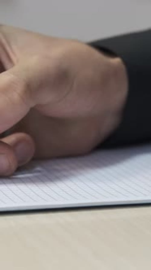 Writing in Notebook with Pen Close Up