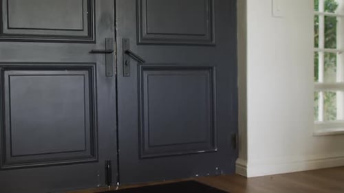 Video of african american girl with schoolbag opening front door, coming home from school