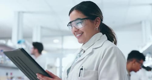 Woman Scientist in Lab Coat Holds Tablet