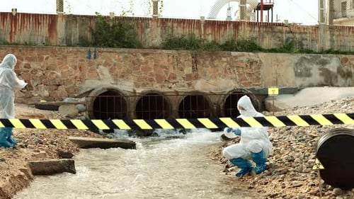 Scientists Taking Water Samples in an Urban Setting