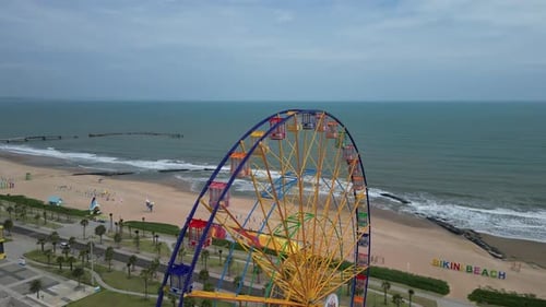 A Colourful Ferris Wheel Spinning Slowly in an Amusement Park at Night with Stars in the Background