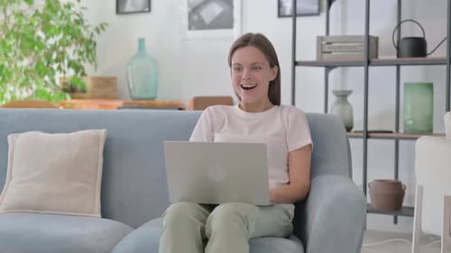 Woman on Sofa Reacts to Good News