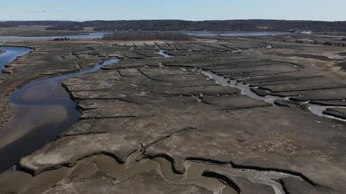 Aerial push forward over a tidal salt marsh in the seacoast town of Scituate, MA USA. Drone. Intrica
