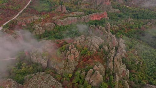 Aerial view of autumn rocks and forest under clouds, Bulgaria.
