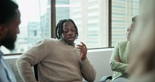 Supportive Colleagues Comfort Troubled Man in Urban Office
