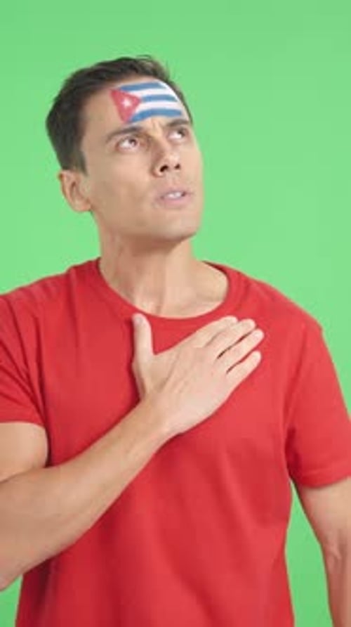 Man Listening to the Cuba National Anthem with Solemnity
