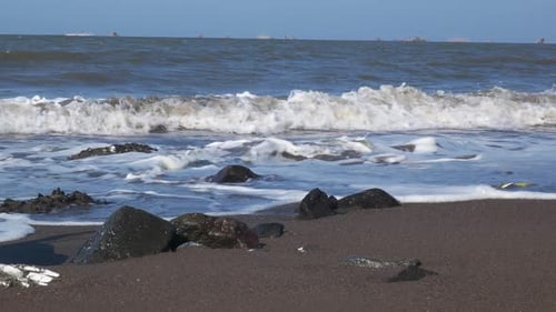 waves on the beach during the day