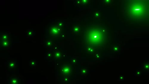 motion glowing particles of green light flying in the dark abstract background