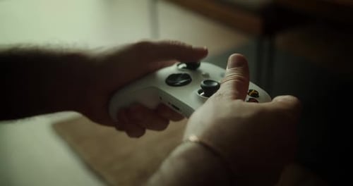 Man Gamer Hands Holding Modern Console for Play Station Closeup Guy Playing Video Games
