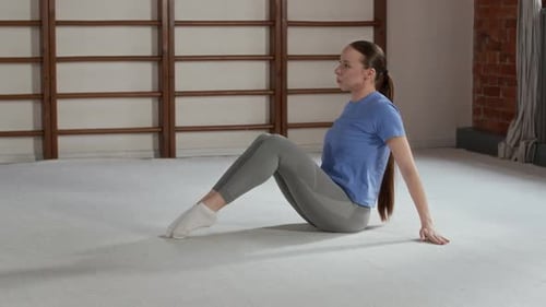 Flexible Woman Practicing Stretching Exercises for Legs, Arms and Back