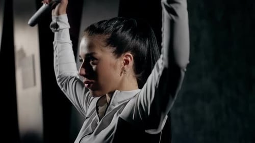 Focused GymGoer Performing Lat Pulldown Exercise Woman Engaged in Lat Pulldown Routine at Gym