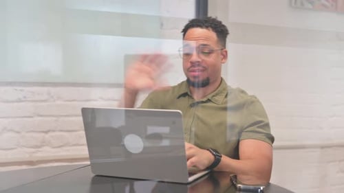 Young Adult Working on Laptop Having Video Call