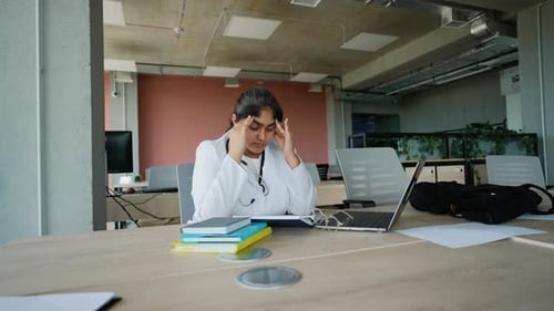 Tired Indian Doctor After a Long Clinic Day Dealing with Stress