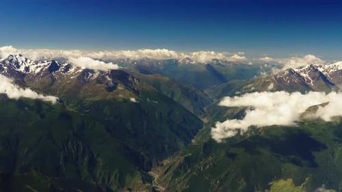 Expansive Mountain Ranges and Cloudy Skies Epic Mountain Ranges Stretch Under a Sky Filled with