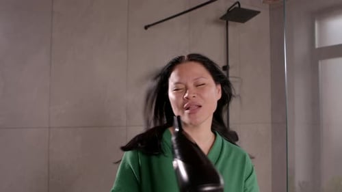 Woman Dries Hair and Sings in Bathroom