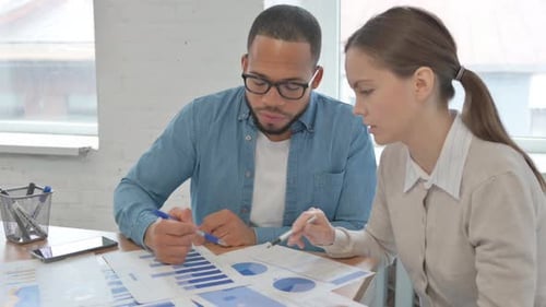 Multi Ethnic People Working on Documents in Office