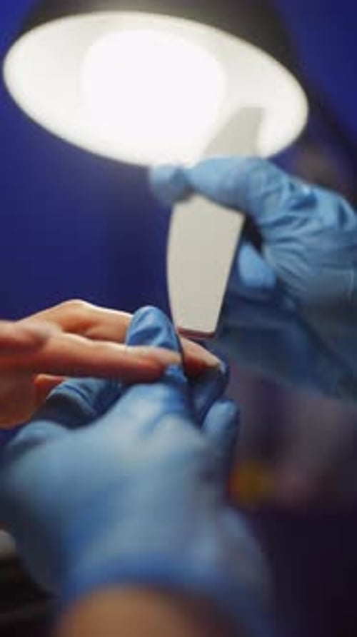 Using a Nail File the Master Shapes a New Beautiful Nail Plate