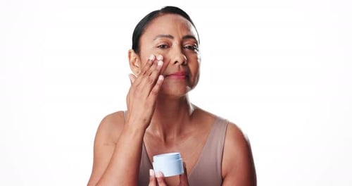 Face, woman and lotion for skincare in studio for patch test, smooth skin and facial hydration