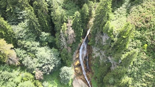 Scenic Aerial View of Waterfall in Lush Forest