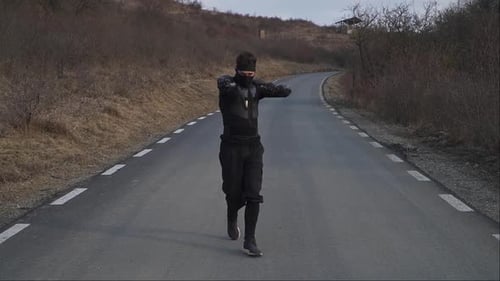 Guerrier ninja masqué en position de combat sur une route déserte