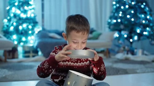 Excited Boy Opens Christmas Gift at Home