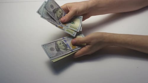 Hands Counting Stack of Hundred Dollar Bills