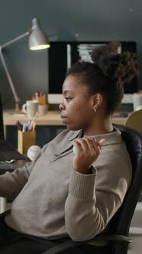 Vertical of Young Female Software Developer Working in Modern Office