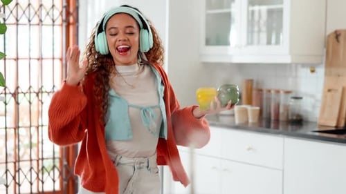 Woman Dances in Kitchen While Cooking Meal