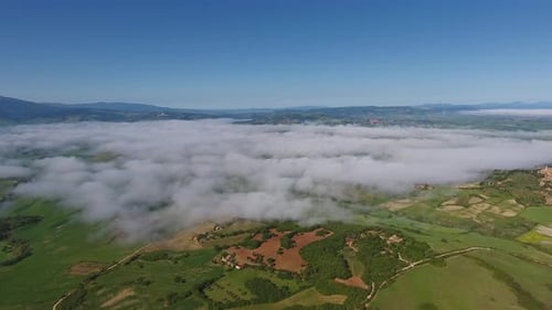 Fog Over Farmland Hill Country in Tuscany Aerial