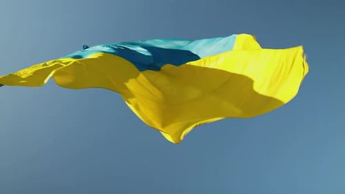 Ukraine Flag Waving Against Blue Sky