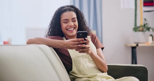Woman, laughing and scroll with phone on sofa for text message, social media post