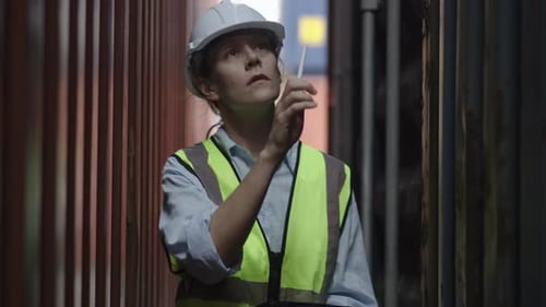 Caucasian Female Industrial Engineer walk along check safety of product in workplace area