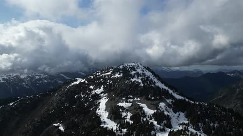 Snowy Canadian Mountain Peak, cloudy sky. British Columbia, Canada.