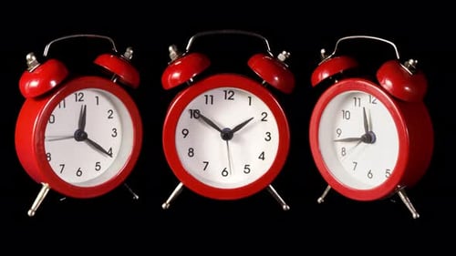 Accelerated Time Passing on Three Red Alarm Clocks