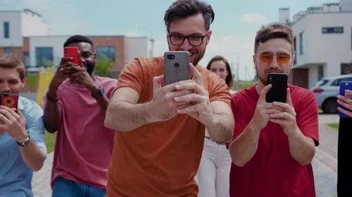Happy Friends Recording Video on Phones Outdoors Together