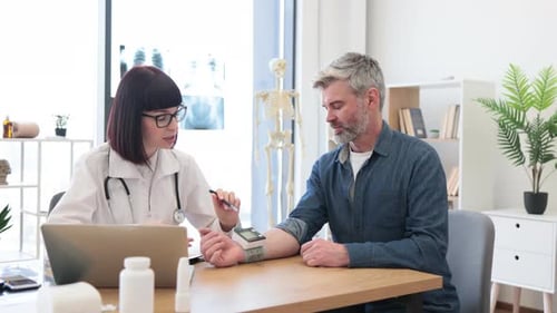 Doctor Consulting with Patient in Medical Office