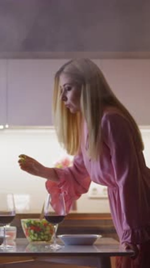 Young Adult Woman Adding Croutons to Wine