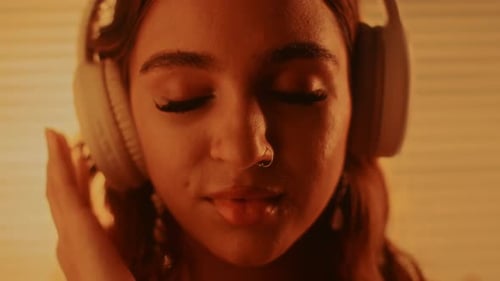 Woman with Headphones Listening to Music