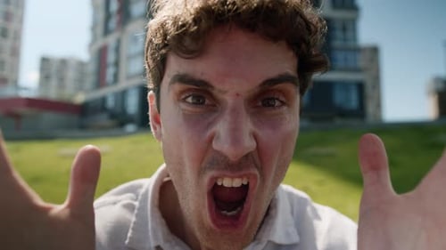 Frustrated Young Adult Man Yelling and Covering Face