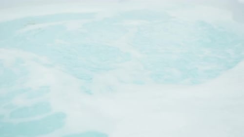 Jacuzzi on bubbling in slow motion without any people in backyard