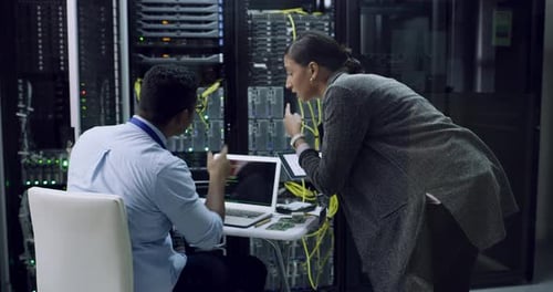 Technicians Collaborate on Servers in Data Center