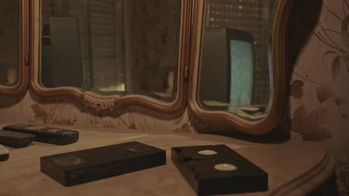 VHS on Dresser and TV Static Reflected in Mirror