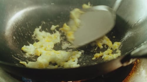 Frying Egg in Wok Pan on Gas Stove for Pad Thai Noodles