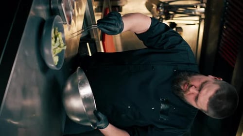 Chef Preparing Green Salad in Restaurant Kitchen