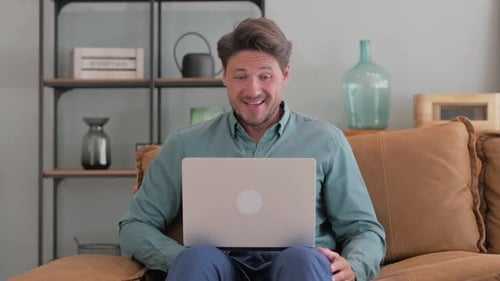 Man on Laptop Video Conference at Home