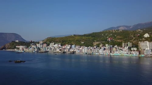 Aerial Establishing Opening Shot of Beautiful Colorful European Cityscape on the Mountains Over Sea