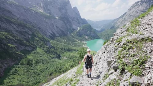 Female hiker walking down a mountain path in the Austrian alps