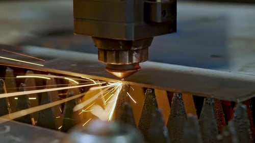 CNC Laser Machine Cutting Bright Sparks On Metal Sheet In Modern Industrial Factory