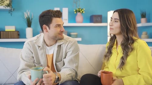 Young Couple Chatting and Relaxing with Hot Drinks