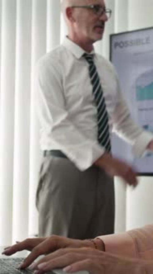 Man Presents Data at a Corporate Meeting